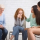 Diverse Ladies Supporting Girl Crying During Group Psychotherapy Indoor